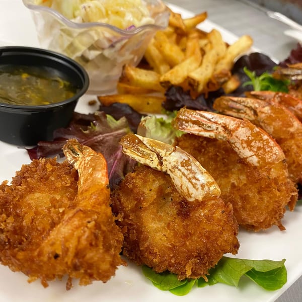 Sauder's Landing fried shrimp platter with fries, coleslaw, and dipping sauce.